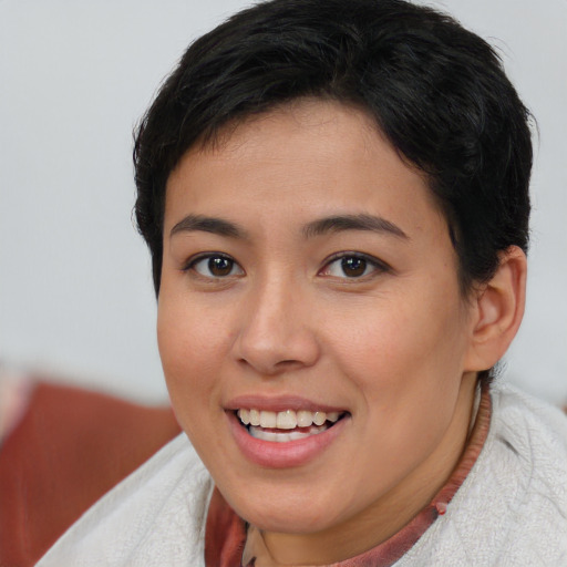 Joyful latino young-adult female with short  brown hair and brown eyes
