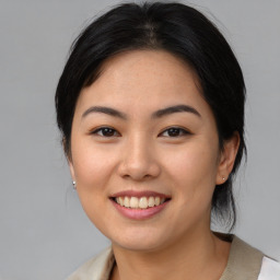 Joyful asian young-adult female with medium  black hair and brown eyes