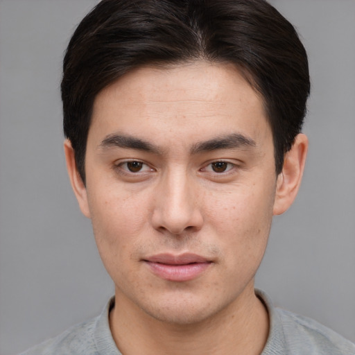 Joyful asian young-adult male with short  brown hair and brown eyes