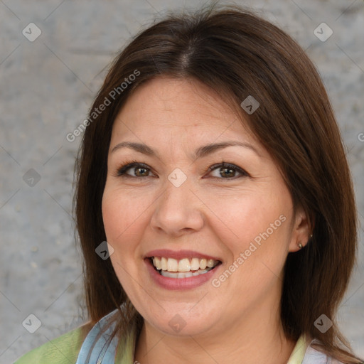 Joyful white adult female with medium  brown hair and brown eyes