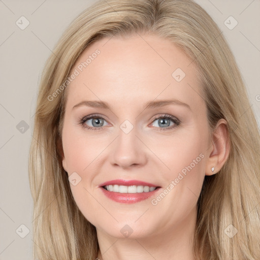 Joyful white young-adult female with long  brown hair and blue eyes