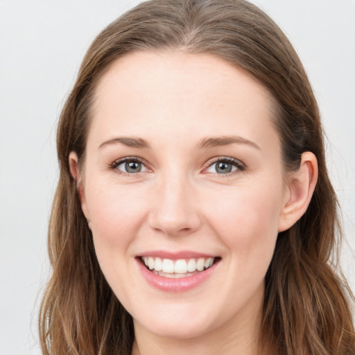 Joyful white young-adult female with long  brown hair and blue eyes