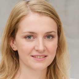 Joyful white young-adult female with long  brown hair and blue eyes