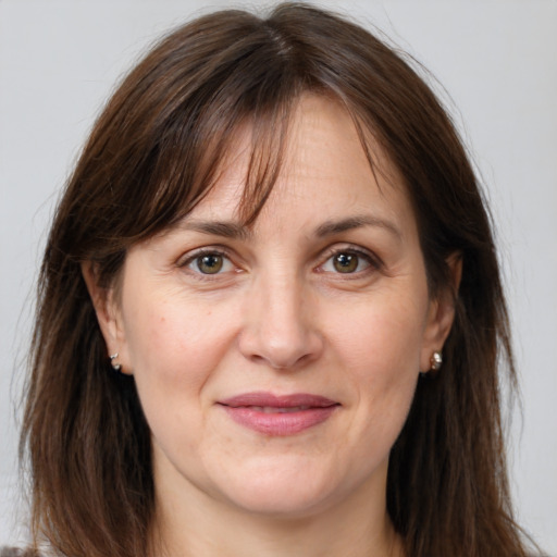 Joyful white adult female with long  brown hair and brown eyes