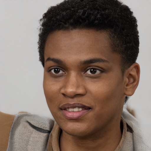 Joyful black young-adult male with short  brown hair and brown eyes