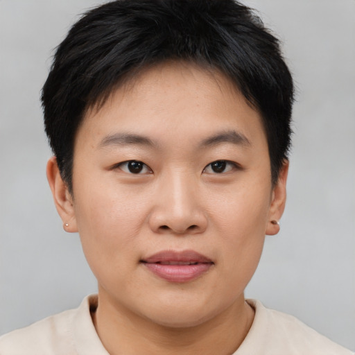 Joyful asian young-adult female with short  brown hair and brown eyes