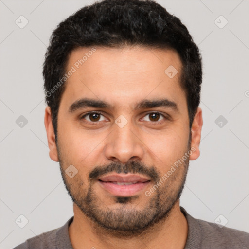 Joyful white young-adult male with short  black hair and brown eyes