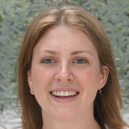 Joyful white adult female with medium  brown hair and grey eyes