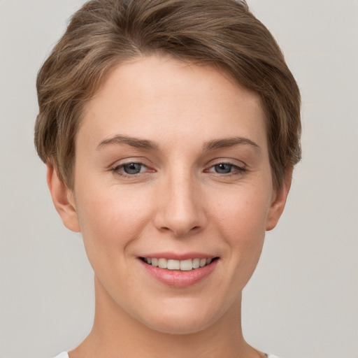 Joyful white young-adult female with short  brown hair and grey eyes