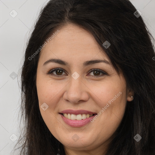 Joyful white adult female with long  brown hair and brown eyes