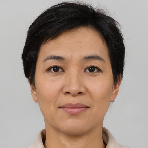 Joyful asian adult female with short  brown hair and brown eyes