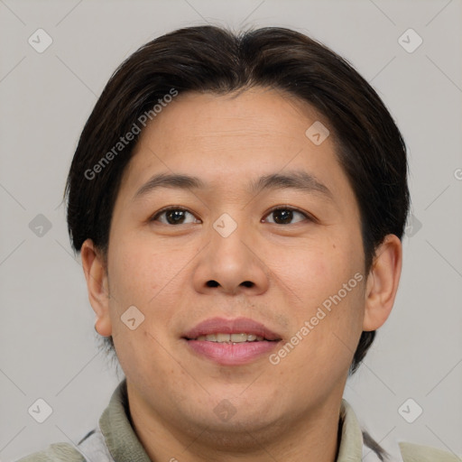 Joyful asian adult male with short  brown hair and brown eyes