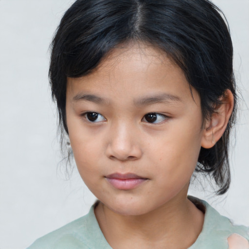 Joyful asian child female with medium  brown hair and brown eyes