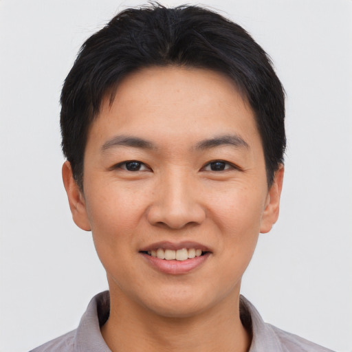 Joyful asian young-adult male with short  black hair and brown eyes