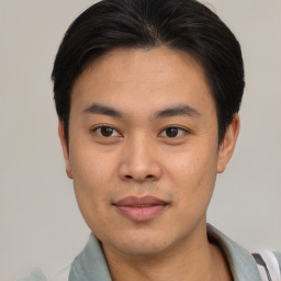 Joyful asian young-adult male with short  black hair and brown eyes