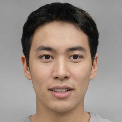 Joyful asian young-adult male with short  black hair and brown eyes