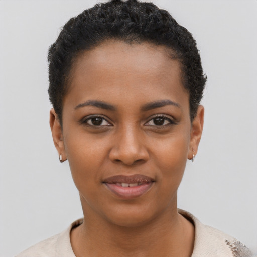 Joyful black young-adult female with short  brown hair and brown eyes