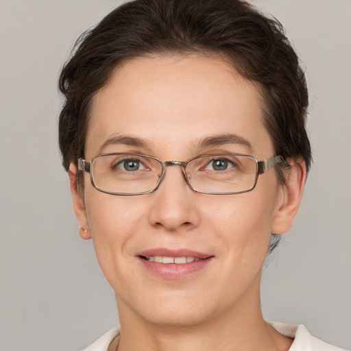 Joyful white young-adult female with short  brown hair and grey eyes