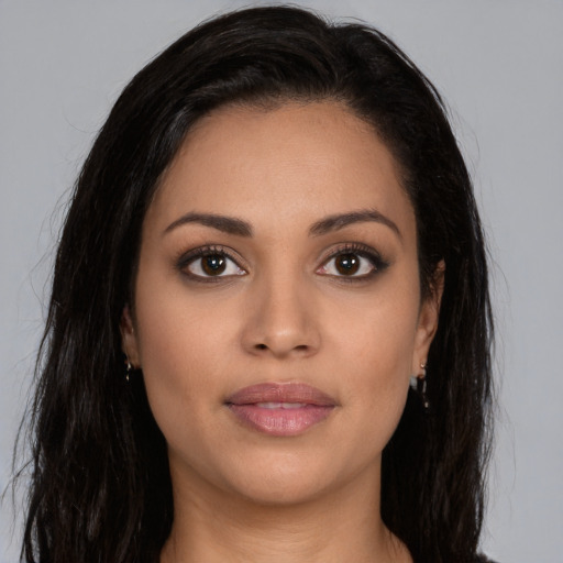 Joyful latino young-adult female with long  brown hair and brown eyes