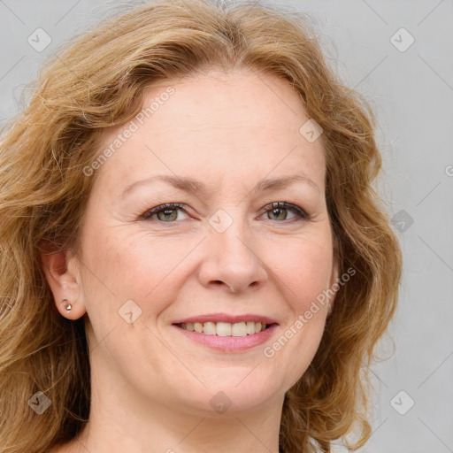 Joyful white adult female with medium  brown hair and blue eyes