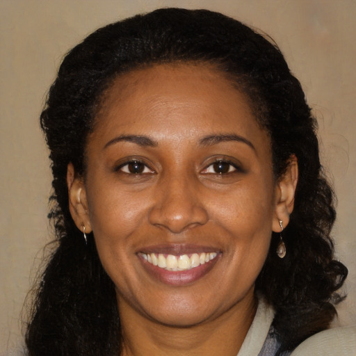 Joyful black young-adult female with medium  brown hair and brown eyes