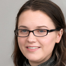 Joyful white young-adult female with long  brown hair and blue eyes