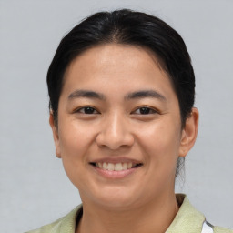 Joyful asian young-adult female with short  brown hair and brown eyes