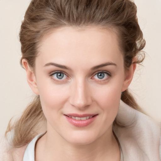 Joyful white young-adult female with medium  brown hair and blue eyes