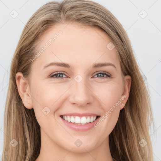 Joyful white young-adult female with long  brown hair and blue eyes