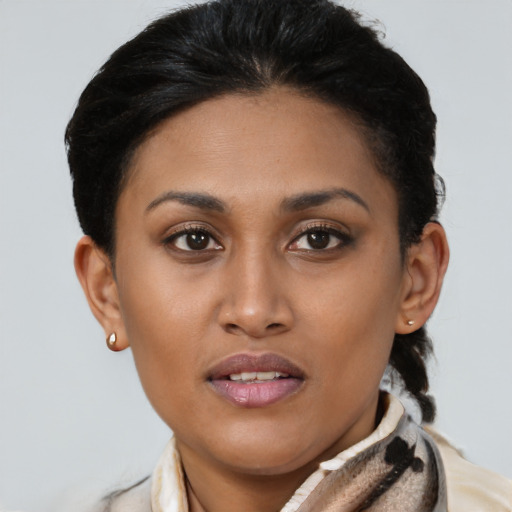 Joyful latino young-adult female with short  brown hair and brown eyes