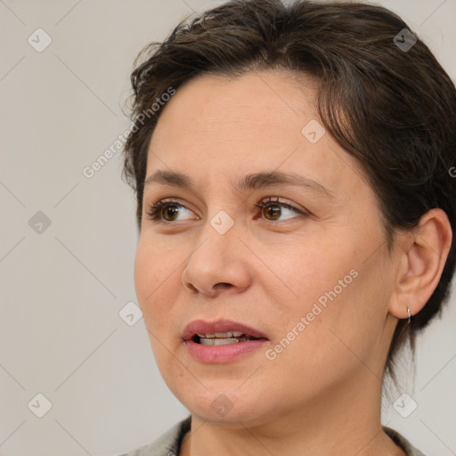 Joyful white adult female with medium  brown hair and brown eyes