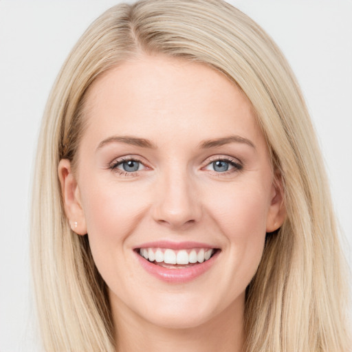 Joyful white young-adult female with long  brown hair and blue eyes