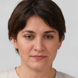 Joyful white adult female with short  brown hair and brown eyes