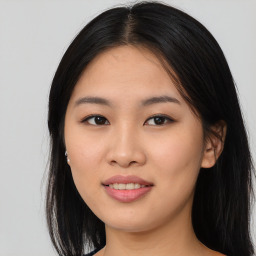 Joyful asian young-adult female with long  brown hair and brown eyes