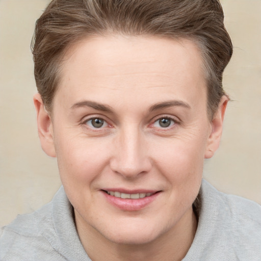 Joyful white adult female with short  brown hair and grey eyes