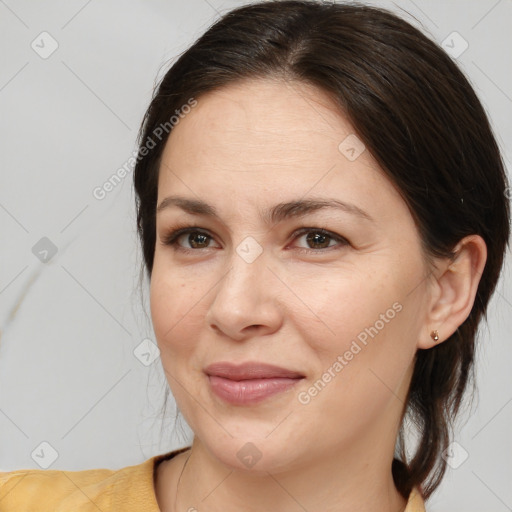 Joyful white adult female with medium  brown hair and brown eyes