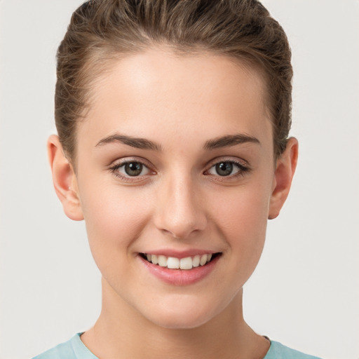 Joyful white young-adult female with short  brown hair and brown eyes