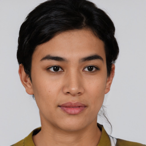 Joyful latino young-adult female with short  black hair and brown eyes