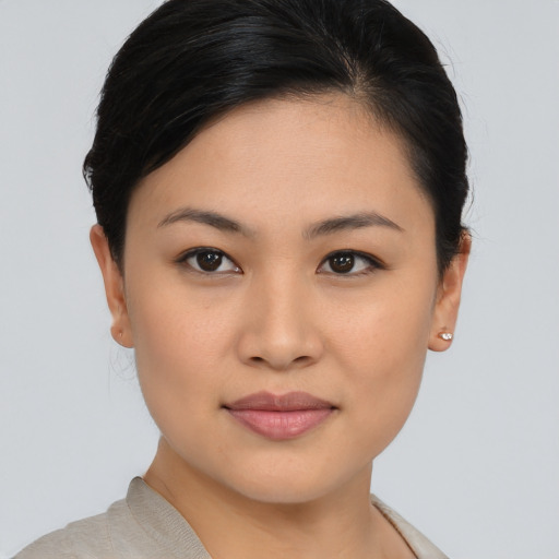 Joyful asian young-adult female with medium  brown hair and brown eyes