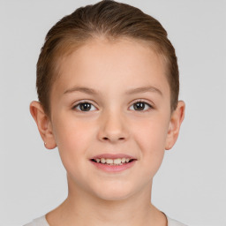 Joyful white child female with short  brown hair and brown eyes