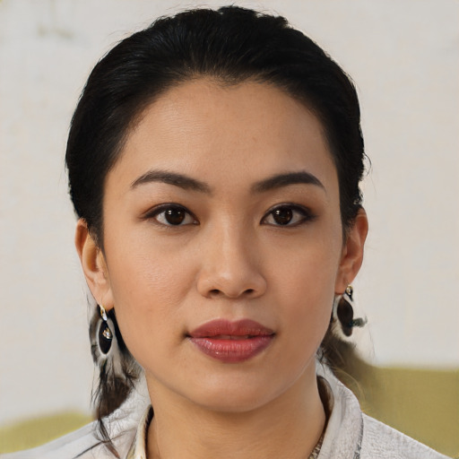 Joyful latino young-adult female with medium  black hair and brown eyes