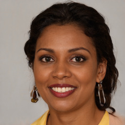 Joyful black young-adult female with medium  brown hair and brown eyes