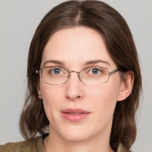 Joyful white young-adult female with medium  brown hair and green eyes