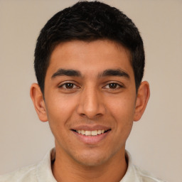 Joyful latino young-adult male with short  brown hair and brown eyes