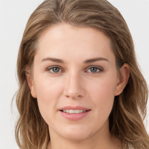 Joyful white young-adult female with long  brown hair and grey eyes