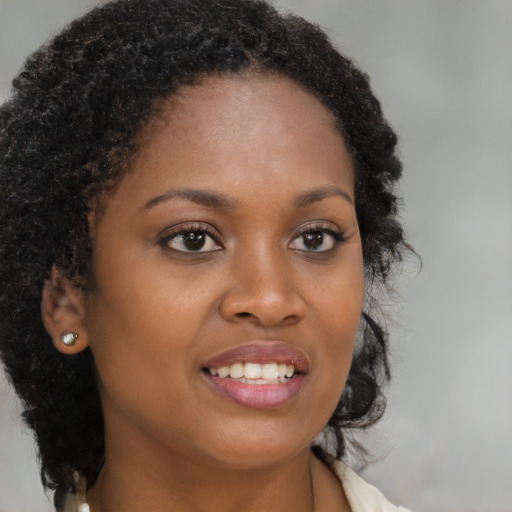 Joyful black young-adult female with medium  brown hair and brown eyes