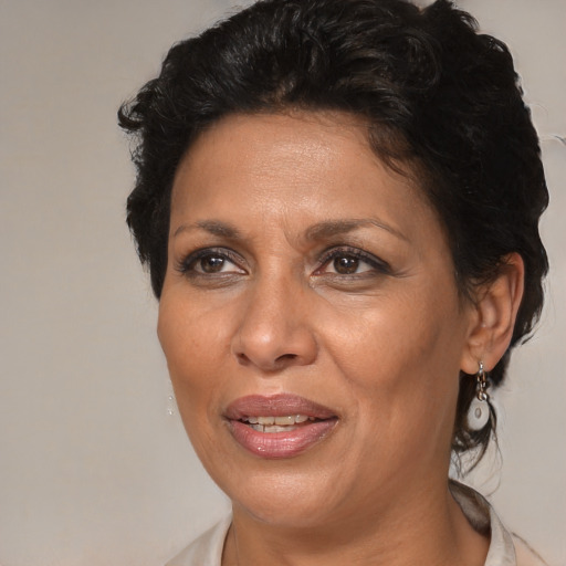Joyful black adult female with medium  brown hair and brown eyes
