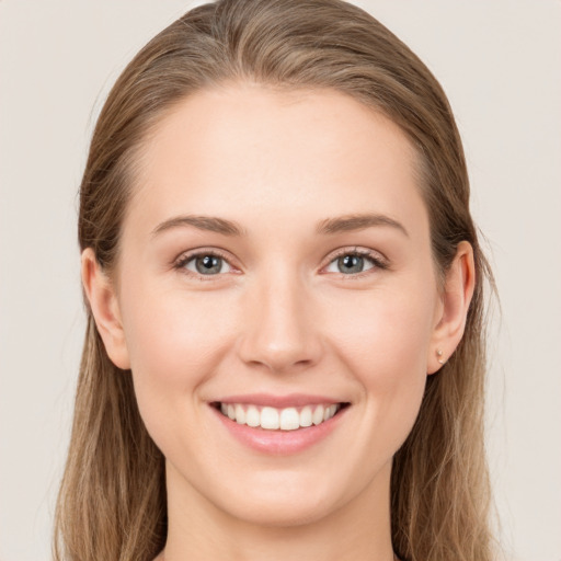 Joyful white young-adult female with long  brown hair and grey eyes