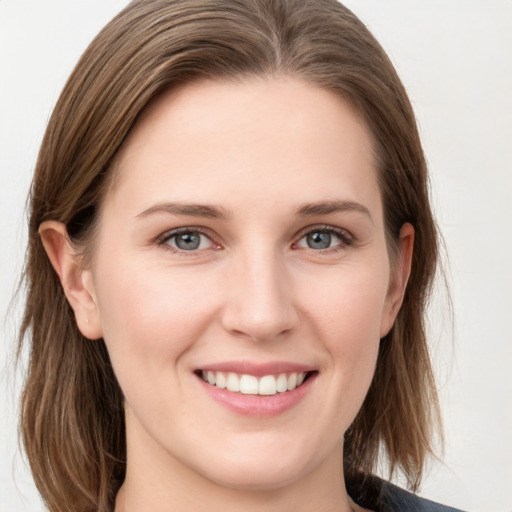 Joyful white young-adult female with medium  brown hair and grey eyes