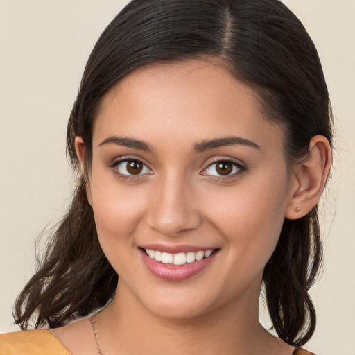 Joyful white young-adult female with long  brown hair and brown eyes